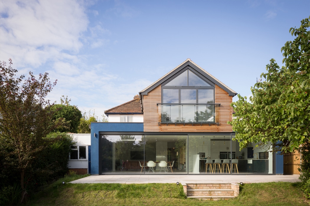 Modern house extension featuring theEDGE2 ultra-slimline glass sliding doors opening onto a patio, maximising natural light and garden views.