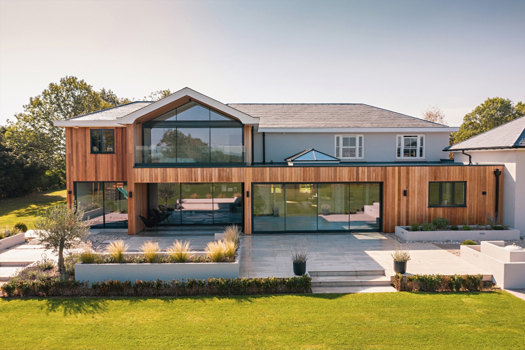Modern home extension featuring theEDGE2.0 ultra-slimline glass sliding doors with minimal frames, maximising natural light and garden views across the contemporary patio area.
