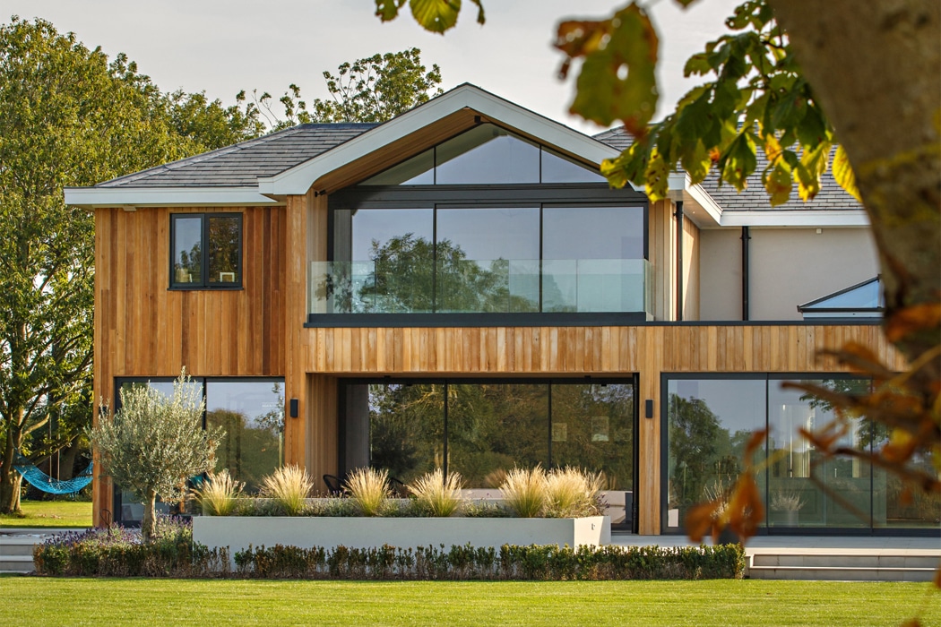 Modern two-storey home featuring theEDGE2 ultra-slimline glass sliding doors with narrow frames, maximising light and views across garden landscape.